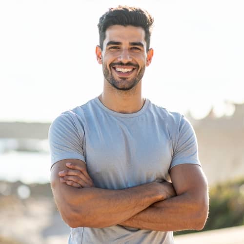 Smiling person standing outdoors
